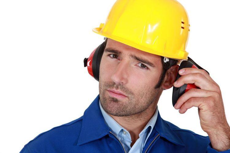 Man removing his earmuff to communicate